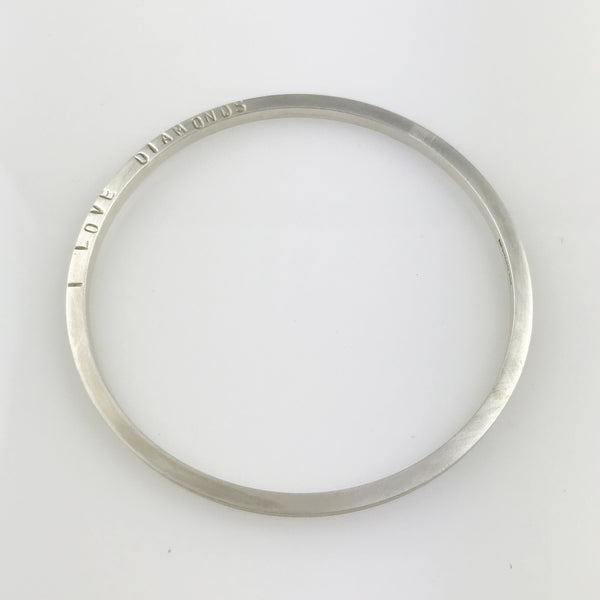 Silver round bangle with the words 'I LOVE DIAMONDS'