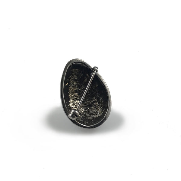 'Best Before' - matt black silver egg brooch with diamond