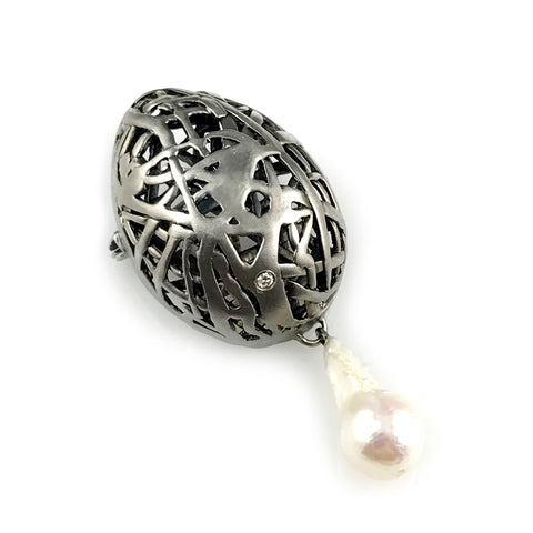 'Best Before' - Matt black silver egg brooch with diamond and baroque pearl drop