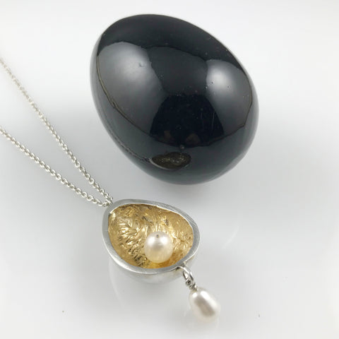 Silver egg pendant with pearls