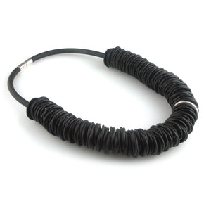 Black rubber necklace with one silver ring